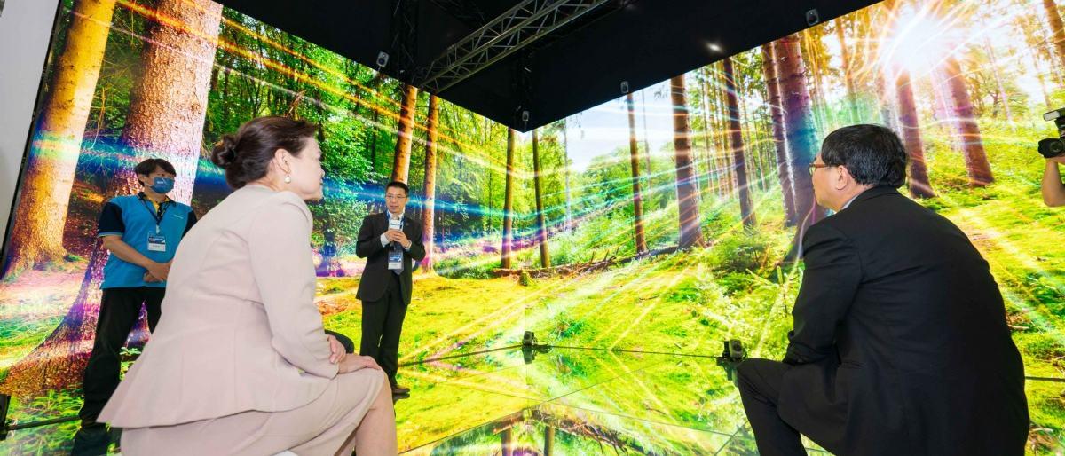 A wide screen display with a forest scene observed by visitors to Touch Taiwan 2023