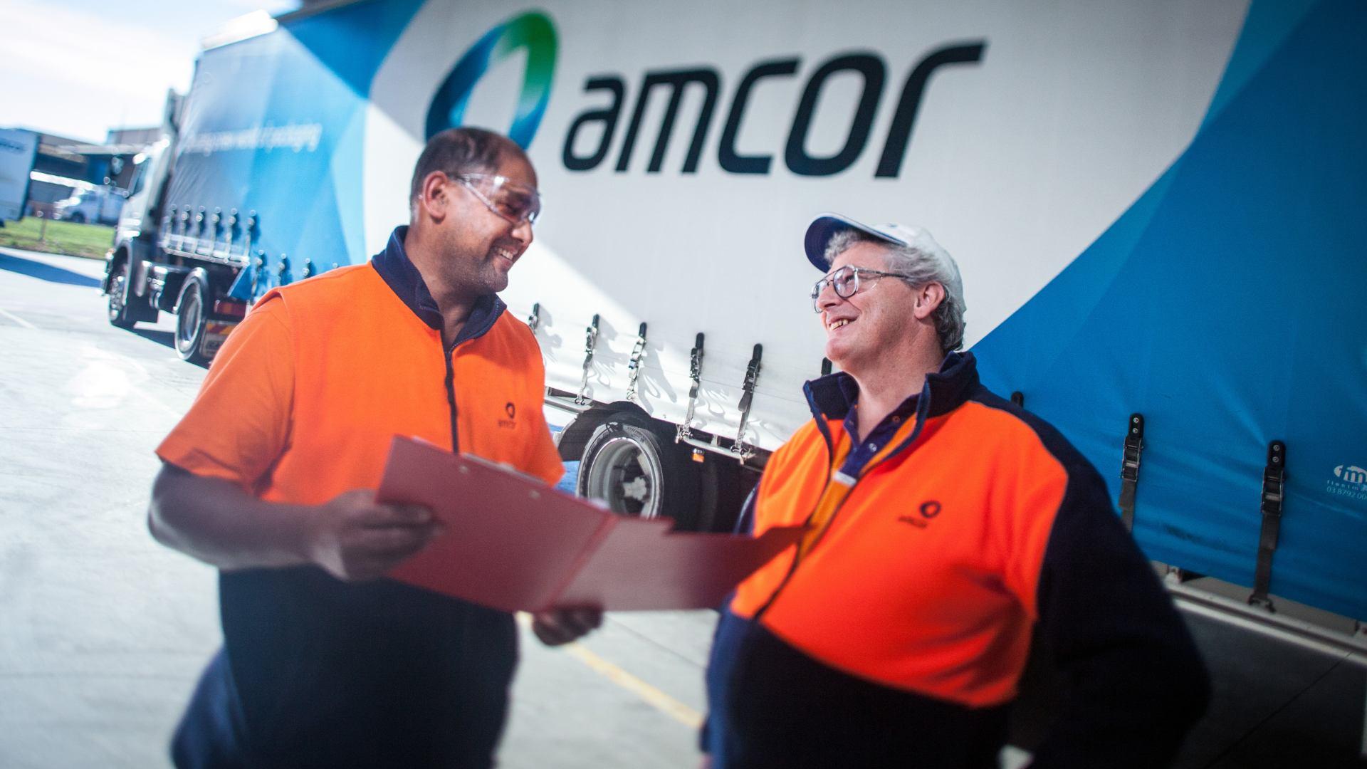 Amcor workers in front of a lorry