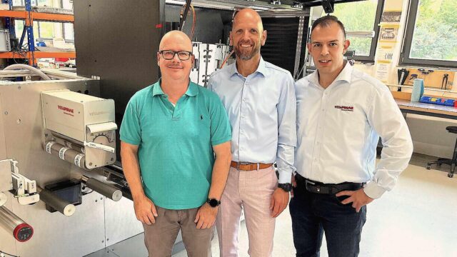 MPRINT’s Sales Manager Sascha Zapf and Sales & Marketing Director David van Loo with Vetaphone’s Ahmed Türkmen in front of one of MPRINT’s MLabel 3 lines under construction at the company’s HQ in Baiersbronn.