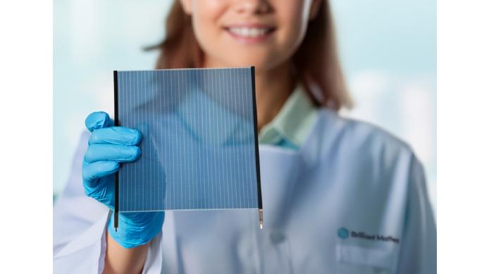 A woman holding a semi-transparent OPV foil